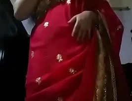 A woman in Indian attire gets intimate with her partner.