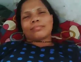 A mature woman in a Tamil video seduces her young neighbor and fulfills her desires in the missionary position.