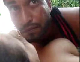 A horny couple having sex in a village field in secret.