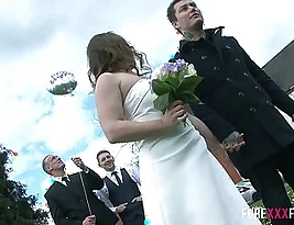 Wife catches up on some intimate moments with the best man during the wedding reception.