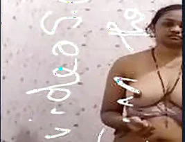 A young Indian woman exposes her breasts and vulva.