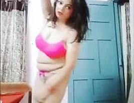 An excited girl exposes her breasts while dancing.