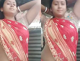 A hot dressed as a hijab woman having fun with a black man on a bed in a video.