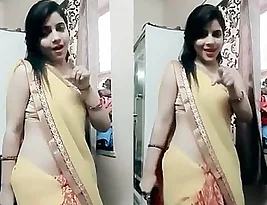 Hot dance performance of a married Indian woman in a red saree
