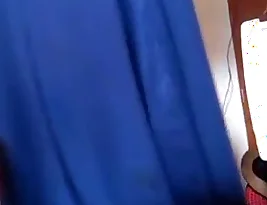 A woman from South Asia removes her head scarf and then exposes herself.